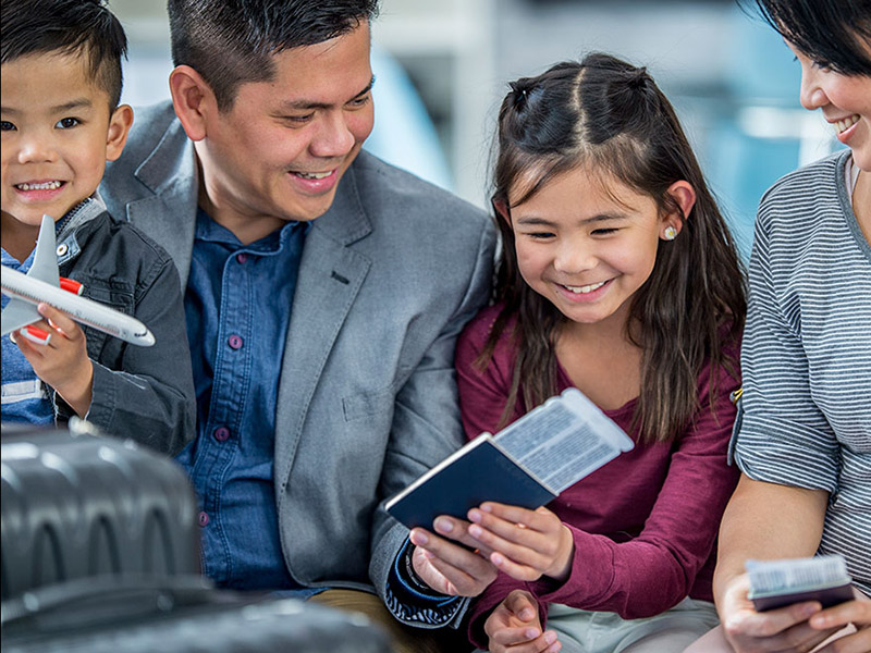family holding passports for employee relocation