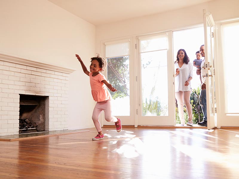 family walking into new home