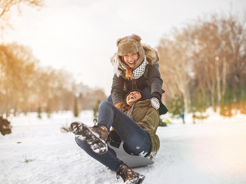 women playing in the snow