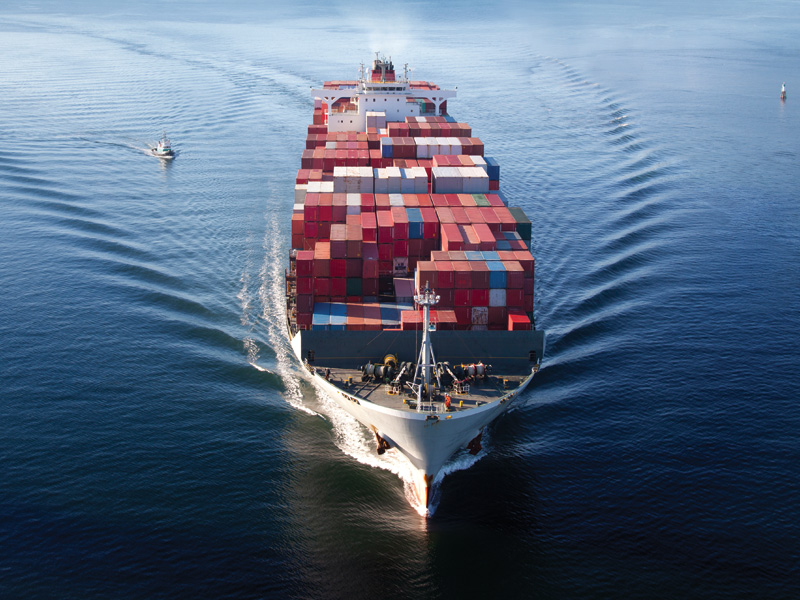 shipping containers being transported on cargo ship over ocean