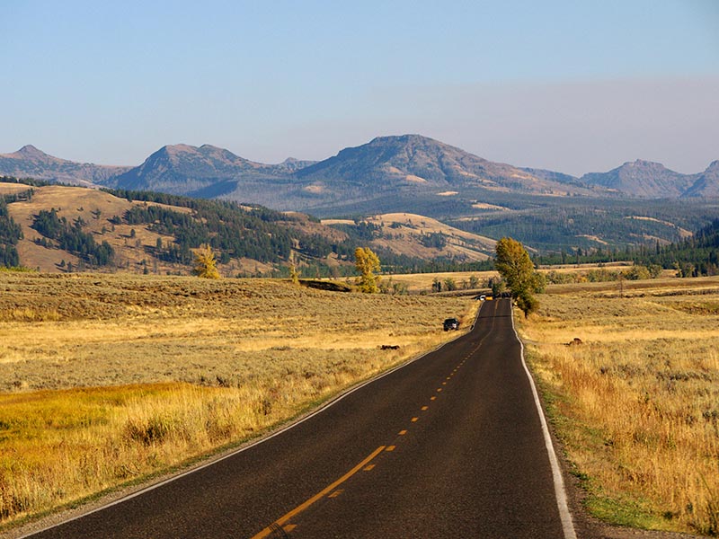 open road with mountains in background