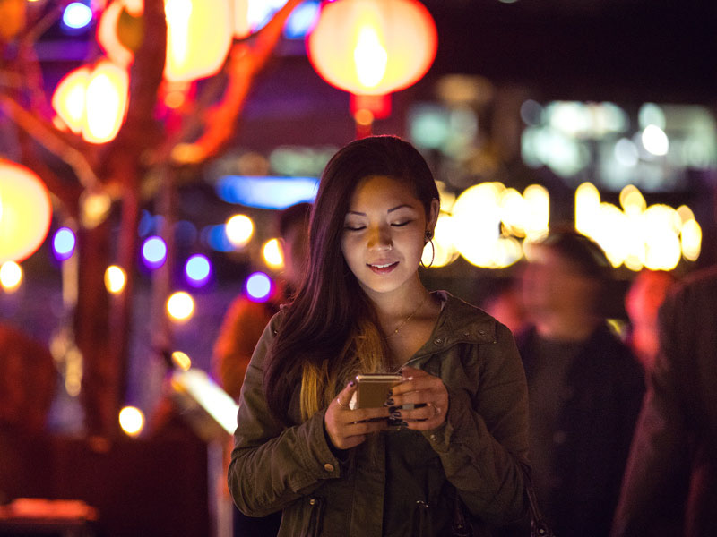 woman looking on phone after Asia relocation