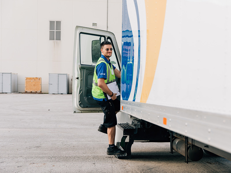 van operator driver getting into moving truck