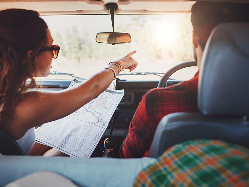young couple in car on roadtrip