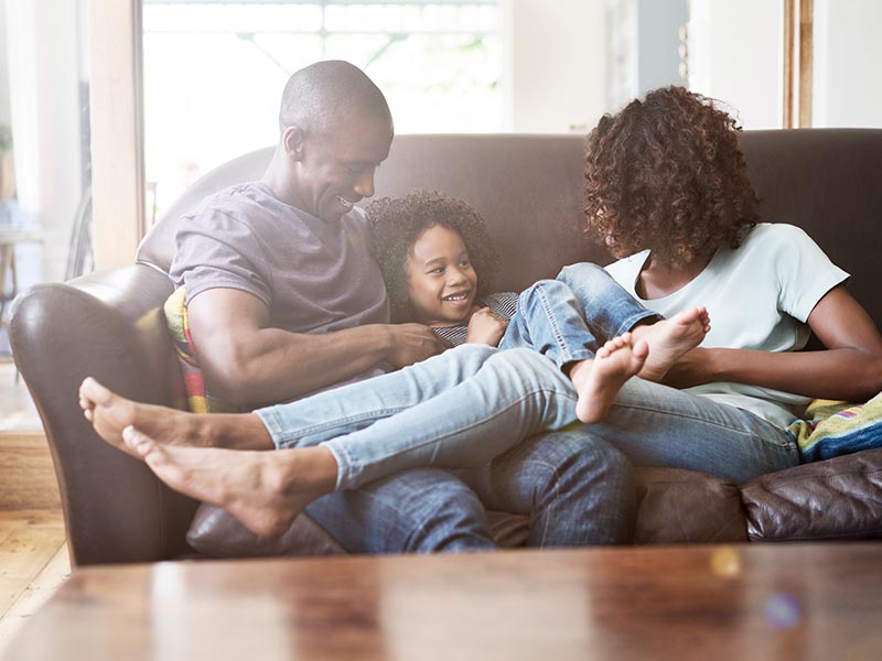family lounging on couch